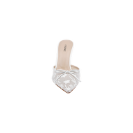 The Prasad Mesh Mule is a single white, pointed-toe mule crafted from embroidered mesh. It showcases delicate floral embroidery, a small bow accent on top, and an open-back design. The beige insole features the LUSINNE branding, and the shoe is presented against a plain white background.