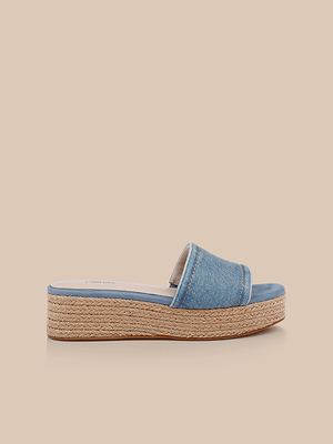 The Ramani Platform Espadrille features a blue denim wide strap and braided jute platform sole, shown against a light beige background—an ideal addition to your spring-summer shoe collection.