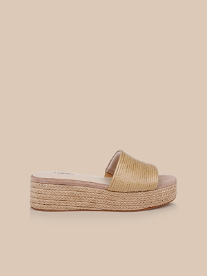 The Ramani Platform Espadrille features a tan raffia upper strap and espadrille-style braided sole, perfect for spring to summer outfits. Shown in profile on a beige background.