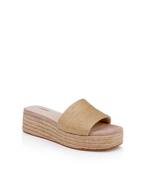 The Ramani Platform Espadrille is a beige slide sandal with a woven straw upper and sole, open toe, and flat chunky heel—ideal for easy warm-weather looks. Shown on a white background.