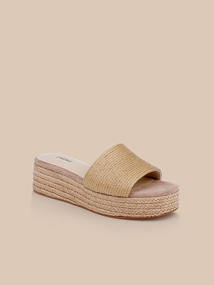 The Ramani Platform Espadrille features a tan woven raffia upper, open toe, and thick braided sole. This slide sandal, shown on a neutral beige background, is perfect for spring to summer style.