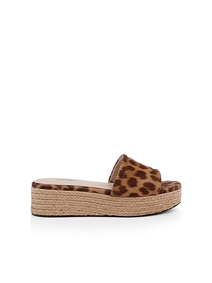 The Ramani Platform Espadrille features a brown and black leopard print suede strap and a woven jute sole. Shown in side profile on a white background, its the ideal slide sandal for effortless summer style.