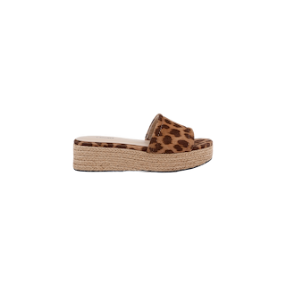 The Ramani Platform Espadrille is a leopard print slide sandal crafted from printed suede, featuring an open toe and a woven espadrille platform sole—an ideal choice for effortless summer style. The sandal is shown from the side on a white background.