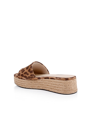 The Ramani Platform Espadrille is a brown leopard-print suede slide sandal with an open toe and thick espadrille platform sole, shown from the rear on a white background—ideal for effortless summer style.