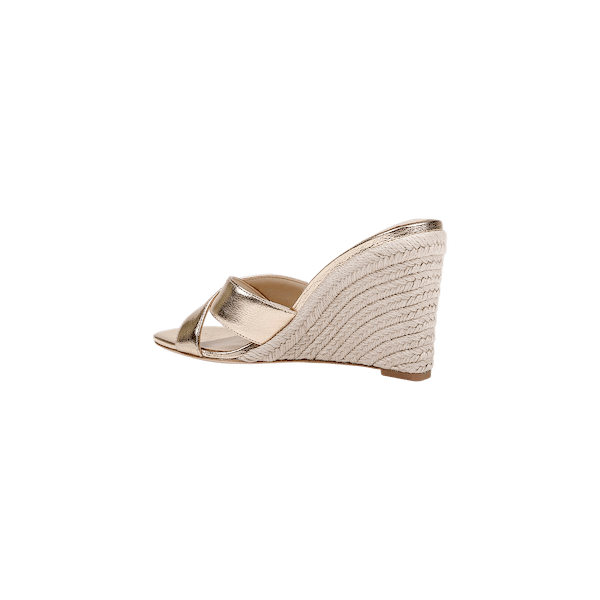 The Rosaline Wedge Espadrille is a gold leather sandal featuring an open toe, crisscross straps, a woven espadrille wedge heel, and a comfortable memory foam insole, displayed on a plain white background.
