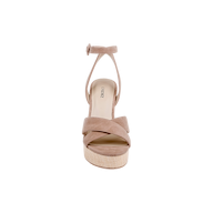 The Sandrine Platform Sandal features crossed tan suede straps, an ankle strap with a small buckle, and sits on a raffia-wrapped wedge in beige, shown from the front against a white background.