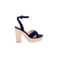 The Sandrine Platform Sandal features navy blue velvet, a thick high heel, an ankle strap with buckle, and a beige raffia-wrapped wedge base, displayed in profile against a plain white background.
