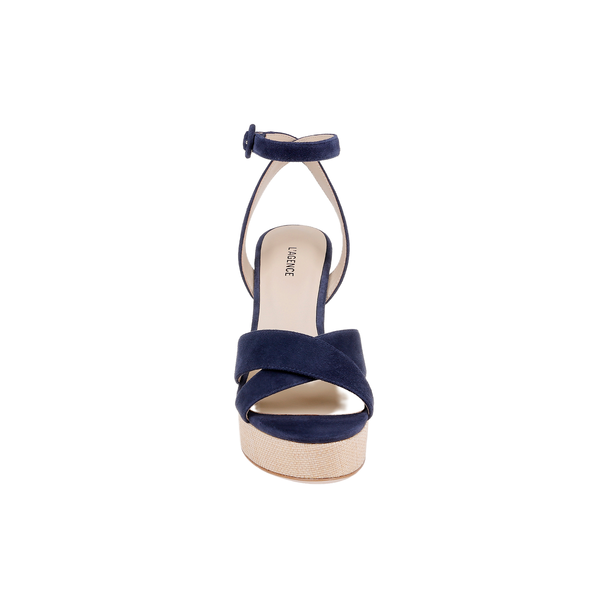 The Sandrine Platform Sandal is shown from the front, featuring navy suede crisscross straps, an ankle strap with a buckle, and a light tan sole elevated by a raffia-wrapped wedge, all set against a plain white background.