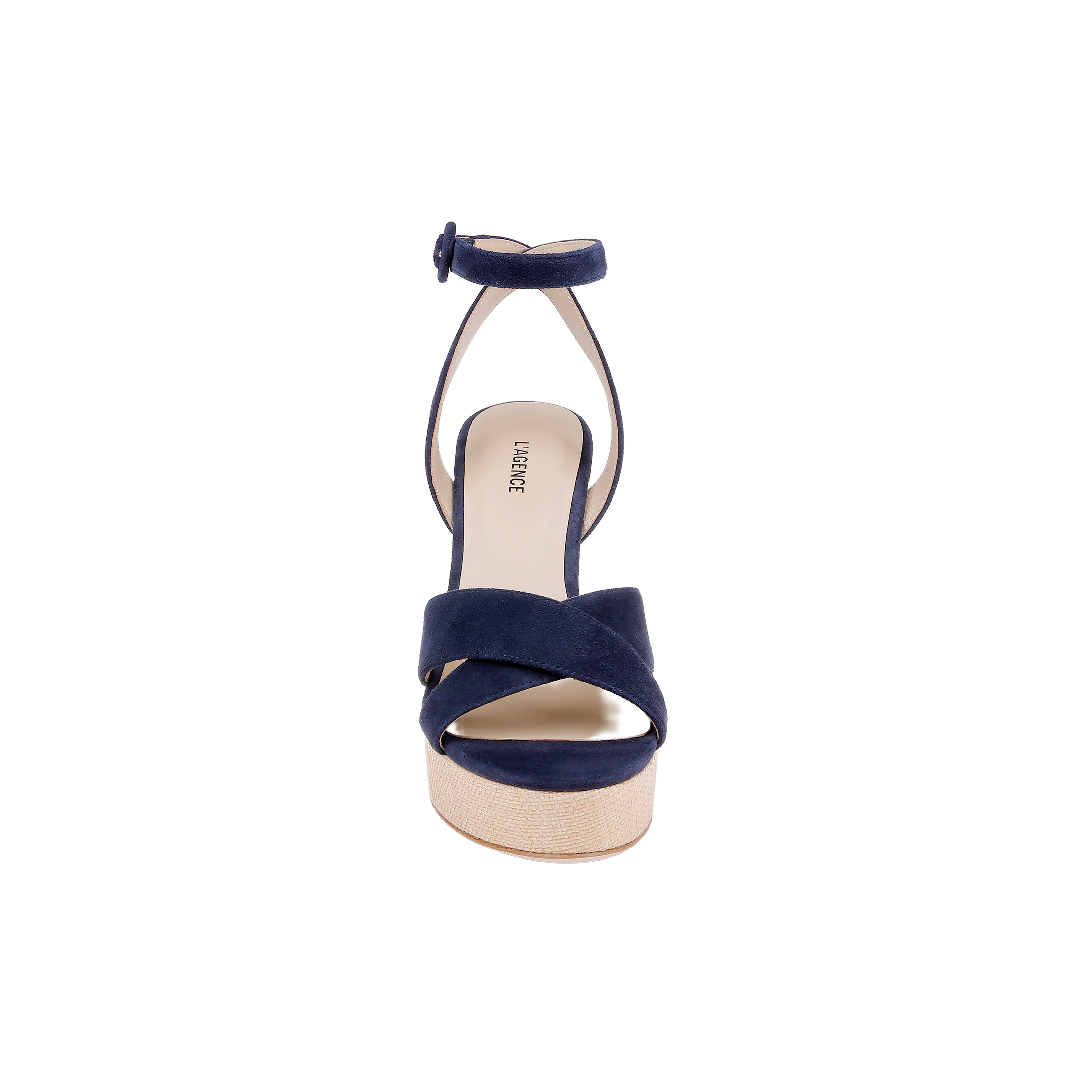 The Sandrine Platform Sandal is shown from the front, featuring navy suede crisscross straps, an ankle strap with a buckle, and a light tan sole elevated by a raffia-wrapped wedge, all set against a plain white background.