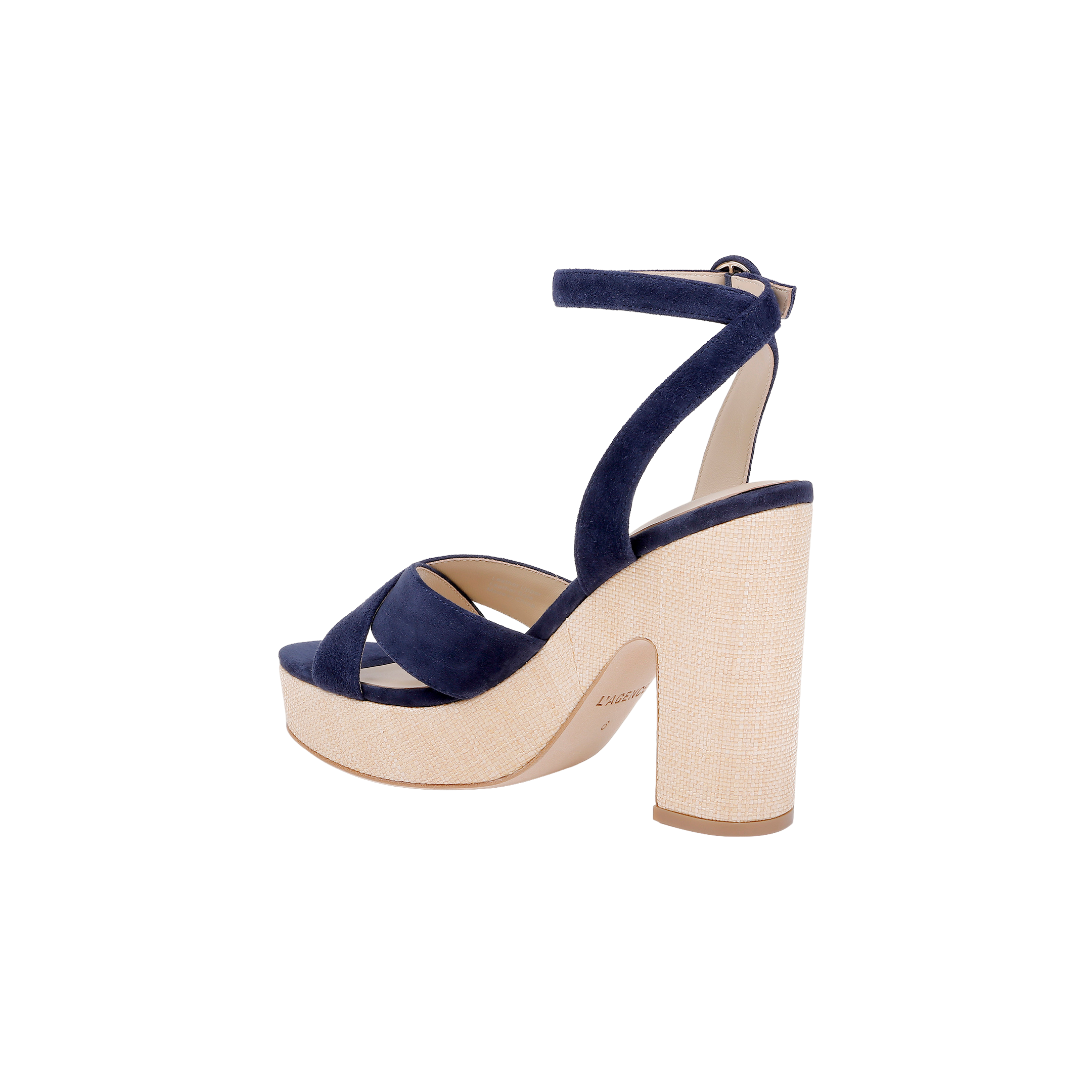 Introducing the Sandrine Platform Sandal: a chic footwear choice featuring a thick beige heel and platform, complemented by navy blue suede crisscross straps and an adjustable ankle strap with buckle. Set against a white background, this modern design is inspired by the look of a raffia-wrapped wedge, offering unique textural appeal.