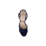 The Sandrine Platform Sandal is a single navy suede heeled sandal with crisscross straps and an ankle buckle, viewed from above on a white background. The beige insole is labeled LAGENCE, while a raffia-wrapped wedge adds natural texture to this sophisticated platform sandal.