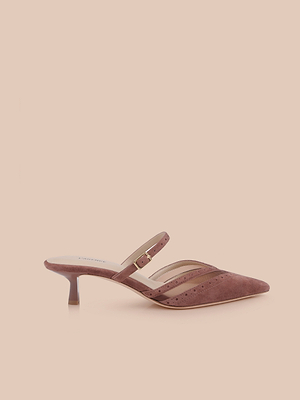 The Shelbie Kitten-Heel Mule in mauve suede has a pointed toe, low heel, thin strap with gold buckle, and chic brogue accents, shown against a light beige background.