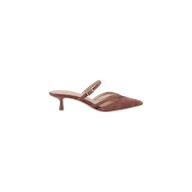 The Shelbie Kitten-Heel Mule is a mauve-colored, suede brogue mule featuring a pointed toe, low kitten heel, and two thin straps across the top—one adorned with a small buckle.