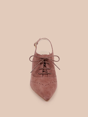 The Shreya Suede Slingback Pump, a mauve oxford stiletto with a suede upper, perforations, front laces, and slingback strap, is displayed upright on a beige background.