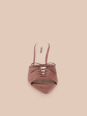 The Thames Suede Sandal features a mauve pointed toe, lace-up front, and low stiletto heel, elegantly displayed against a solid light beige background.