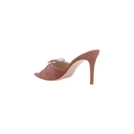 The Thames Suede Sandal is a single mauve suede high-heeled mule featuring a pointed toe, stiletto heel, side cut-out, and a decorative bow on the upper, displayed against a white background.