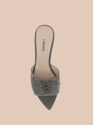 The Thames Suede Sandal is a grey mule featuring a pointed toe, lace-up detail, stiletto heel, and LAGENCE-branded memory foam insole, displayed on a light peach background.