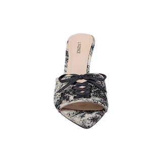 Introducing the Thames Sandal: a pointed-toe mule inspired by classic design, featuring a striking black and white jungle brocade print fabric, black lace-up detailing, and a beige insole embossed with LAURENCE—all set against a white backdrop.
