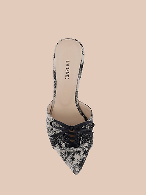 The Thames Sandal features a pointed toe, stiletto heel, black and white distressed pattern, lace-up detail, open sides, and LAGENCE on the beige insole, shown against a plain light tan background.
