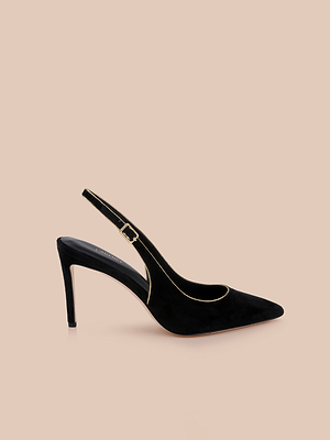 The Vichy Slingback Pump is a black suede stiletto with a pointed toe, slim heel, and elegant gold piping, shown against a plain beige background.