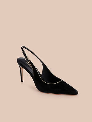 The Vichy Slingback Pump is a black suede stiletto with a pointed toe and elegant gold piping, shown on a beige background.