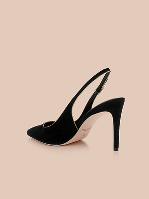 The Vichy Slingback Pump, a black suede stiletto with a pointed toe and slim heel, is displayed in side profile against a beige background.