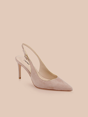 The Vichy Slingback Pump is a light pink stiletto with a pointed toe, slim high heel, gold buckle on the ankle strap, gold piping accents, and a beige inner lining, shown against a light peach background.