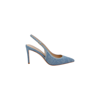 The Vichy Slingback Pump is a light blue denim high heel shoe featuring a pointed toe, a sleek slingback design, and a thin stiletto heel, displayed from the side against a plain white background.