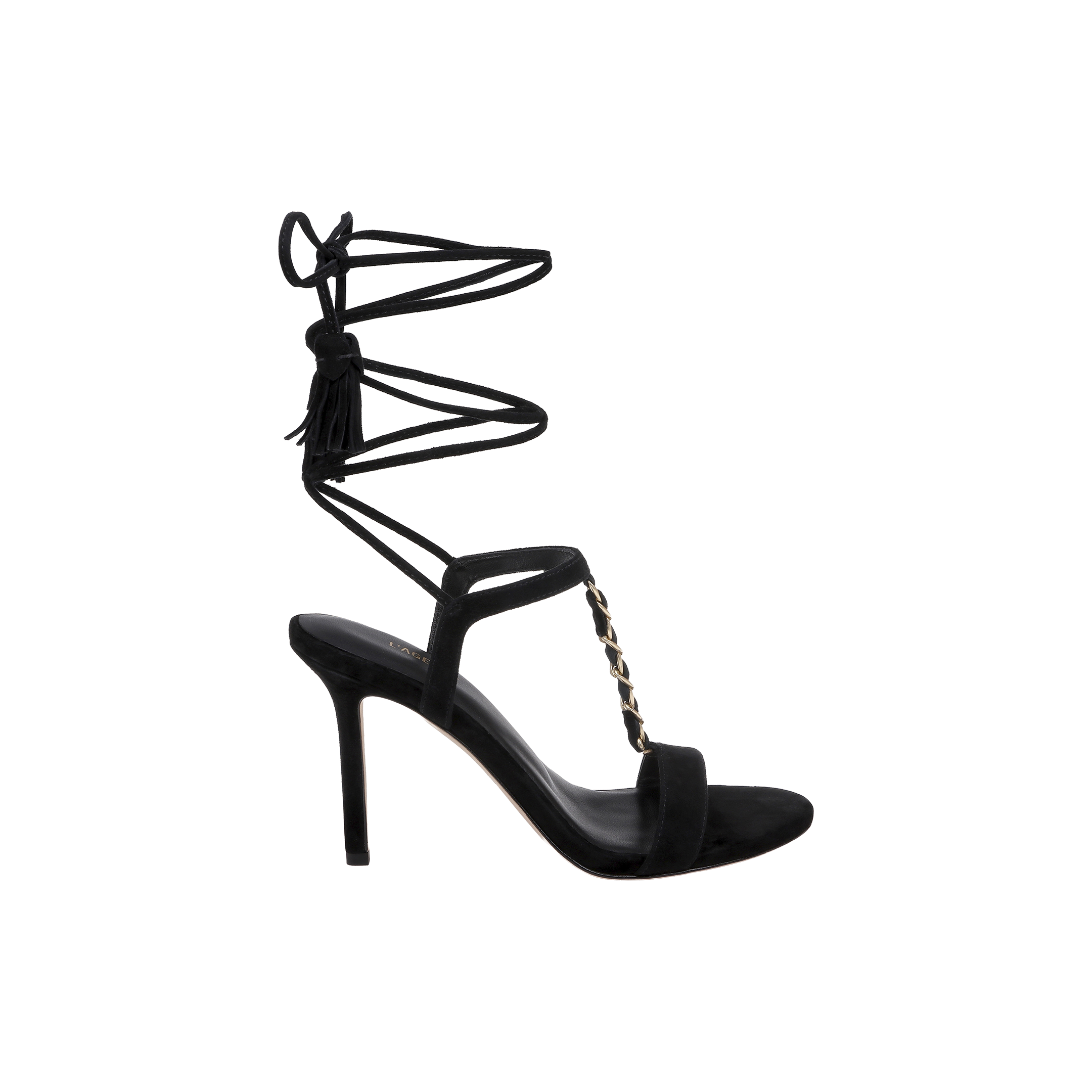 The Bond Suede Sandal features a black strappy design with an open toe, a gold chain accent on the front strap, and long lace-up ankle straps that tie in a bow at the back for a bold look.
