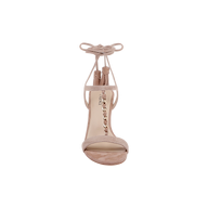 The Bond Suede Sandal—a tan suede strappy heel sandal featuring ankle tie straps, tassels, and a gold chain detail on the front—is displayed from the front against a plain white background.