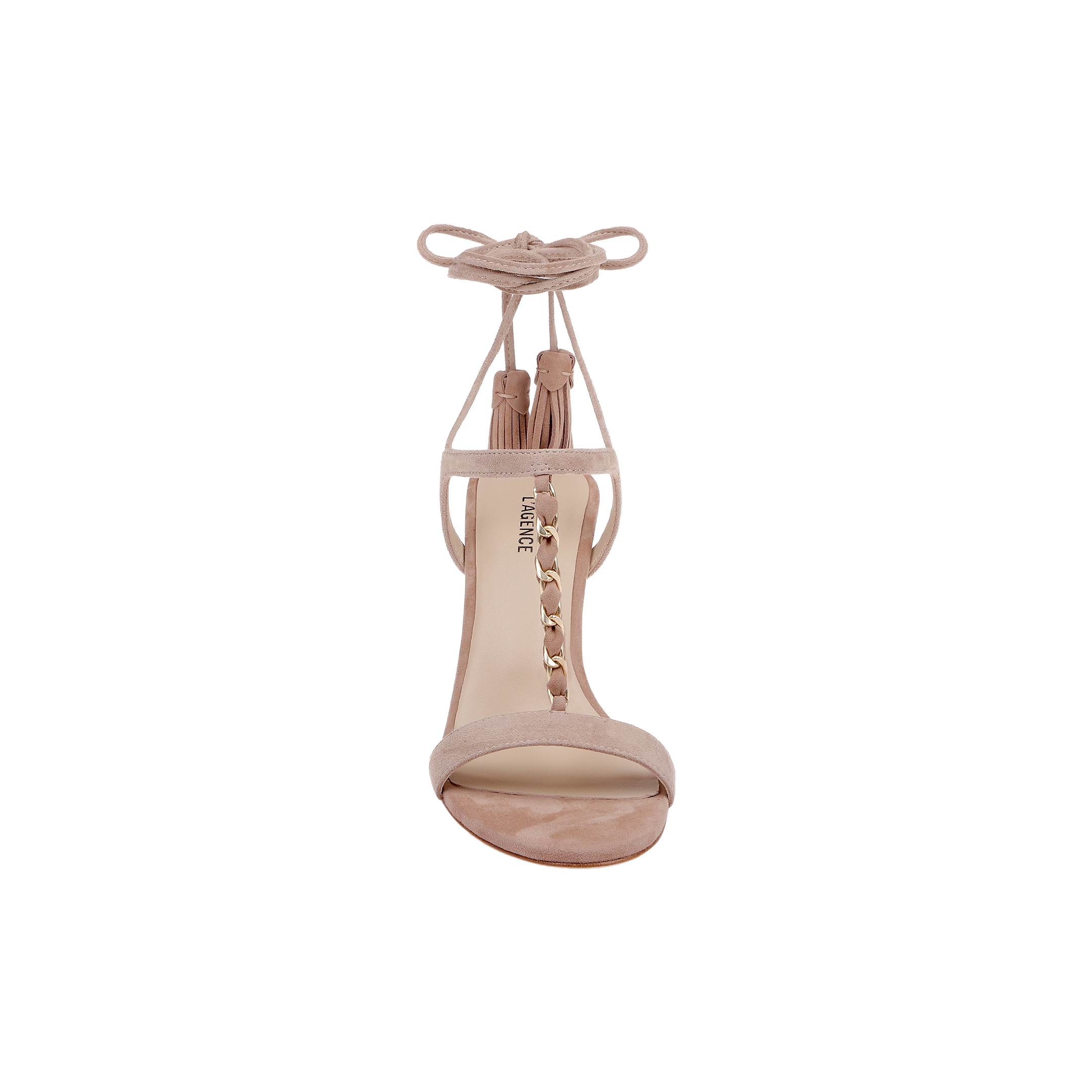 The Bond Suede Sandal—a tan suede strappy heel sandal featuring ankle tie straps, tassels, and a gold chain detail on the front—is displayed from the front against a plain white background.