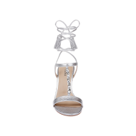 Bond Leather Sandal in silver leather, featuring a high heel and ankle wrap laces with tassel ends, designed with strappy details and gemstone embellishments along the T-strap, shown from above on a white background.