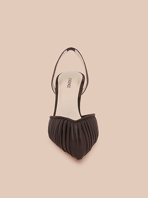 The Bowery Mesh Slingback Pump, featuring a black ruched mesh vamp and pointed toe, is shown from above on a beige background.