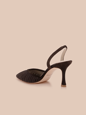 The Bowery Mesh Slingback Pump is a black heeled mule featuring a ruched mesh vamp, pointed toe, slingback strap, and curved stiletto heel, shown against a light beige background.