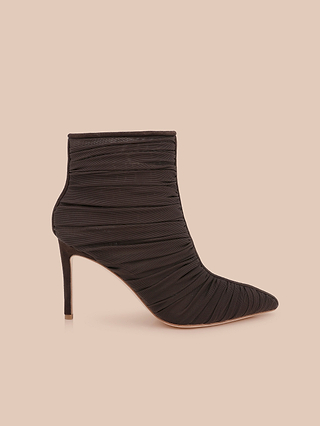 Fulton Mesh Bootie in black, featuring a pointed toe, ruched mesh fabric design, and a slim stiletto heel, displayed on a light beige background.