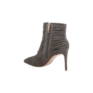 The Fulton Mesh Bootie in smoke grey features a pointed toe, ruched mesh fabric detailing, and a side zipper with a gold pull tab, shown from the side against a white background.