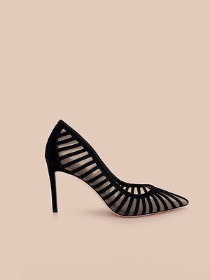 The Lenox Mesh Pump is a black pointed-toe heel with a see-through mesh upper and horizontal black stripes, shown against a plain beige background.