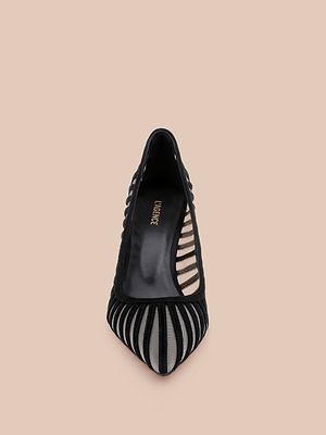 The Lenox Mesh Pump is a black pointed-toe suede shoe with a mesh upper featuring sheer striped panels and a closed toe, shown from above on a beige background.