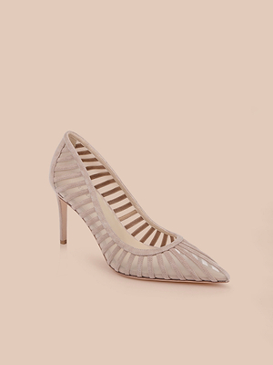 The Lenox Mesh Pump is a blush pink suede shoe with a pointed toe and mesh panel detailing, showcased on a solid light peach background.