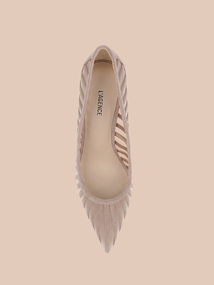 A top view of the Lenox Mesh Pump—a single beige pointed toe suede shoe with sheer striped details and LAGENCE branding on the insole—set against a light beige background.