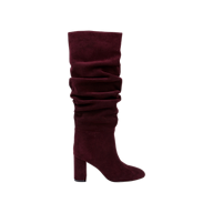The Fletcher Boot, a single knee-high, slouchy suede boot in rich burgundy, is displayed against a plain white background. Featuring a rounded toe and high block heel, this bohemian-chic boot effortlessly blends comfort and style.