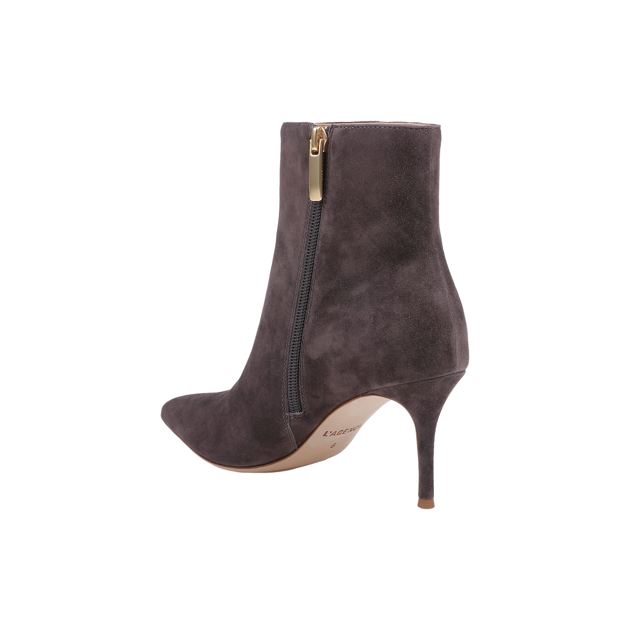 The Houston Bootie is a dark gray suede ankle boot featuring a pointed toe, side zipper, and a high stiletto heel. It has a light brown sole and is shown on a plain white background.