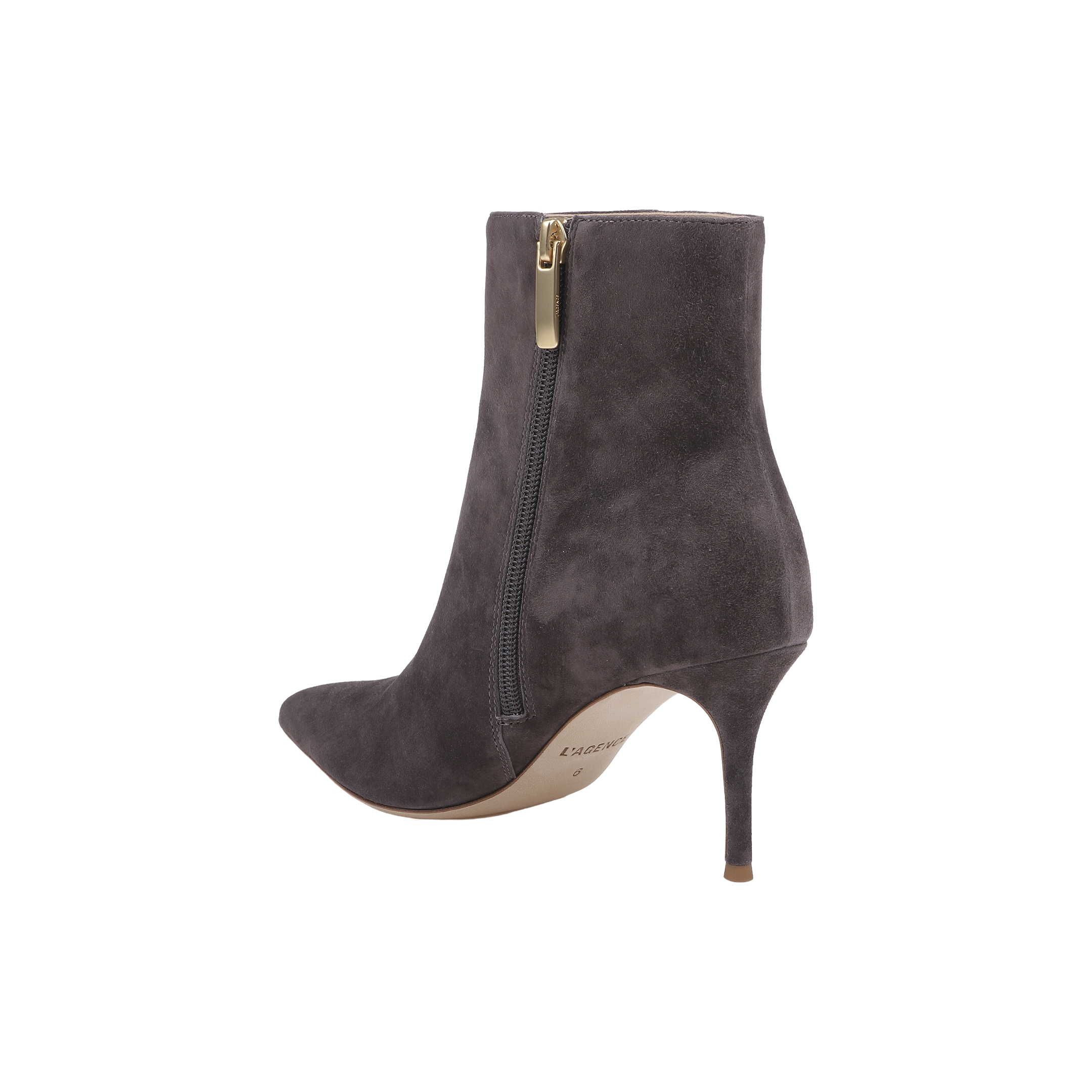 The Houston Bootie is a dark gray suede ankle boot featuring a pointed toe, side zipper, and a high stiletto heel. It has a light brown sole and is shown on a plain white background.