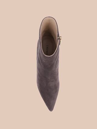 Top view of the Houston Bootie in gray suede, showcasing its pointed toe and gold side zipper, displayed against a light beige background.