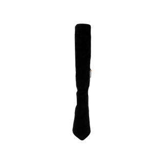 The Herald Boot, a single black suede boot with a pointed toe and a sleek stiletto heel, is displayed upright against a plain white background.