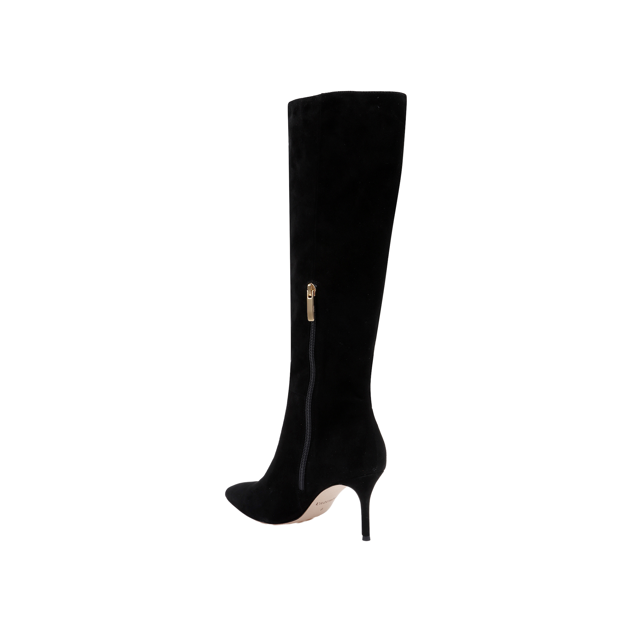 The Herald Boot is a black suede, knee-high boot featuring a pointed toe, stiletto heel, and a gold side zipper. Displayed against a plain white background, this boot highlights its sleek and elegant design.