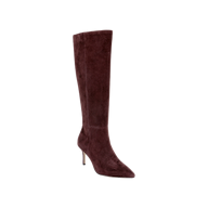 The Herald Boot is a single knee-high, pointed-toe heeled boot in dark burgundy suede, featuring a slender stiletto heel and displayed on a plain white background.