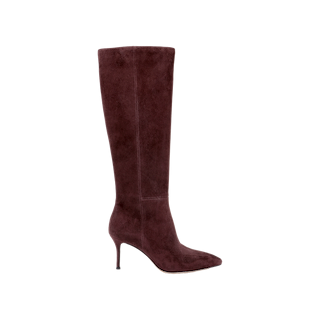 The Herald Boot, a single knee-high burgundy suede style featuring a pointed toe and slender stiletto heel, is showcased against a plain white background.