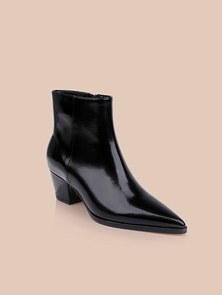 The Vesey Bootie, a single black leather ankle boot with a shiny finish, pointed toe bootie silhouette, and low block heel, is photographed against a plain beige background.