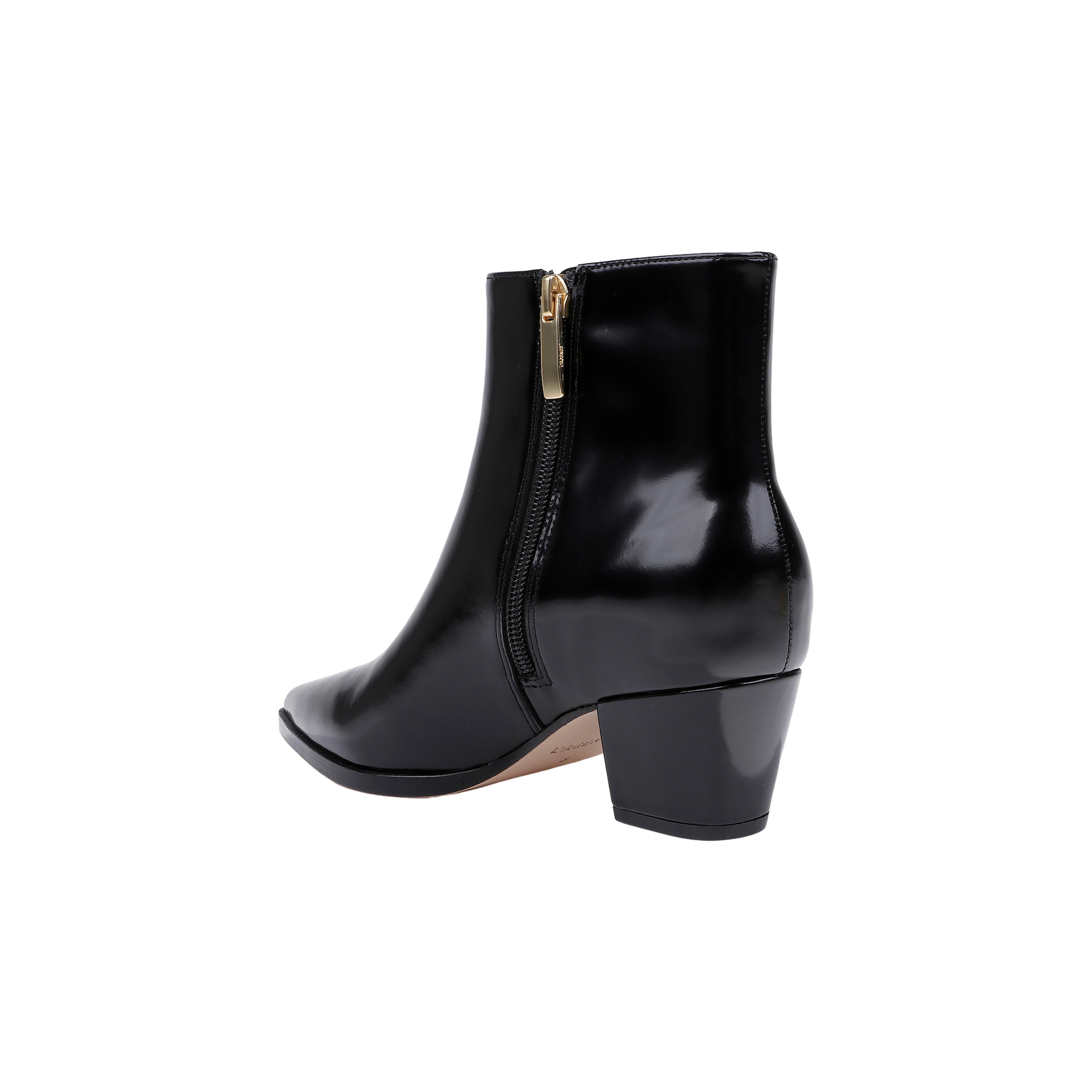 The Vesey Bootie, crafted in black leather with a shiny finish, features a pointed toe, side zipper, and a mid-height block heel, shown against a white background.